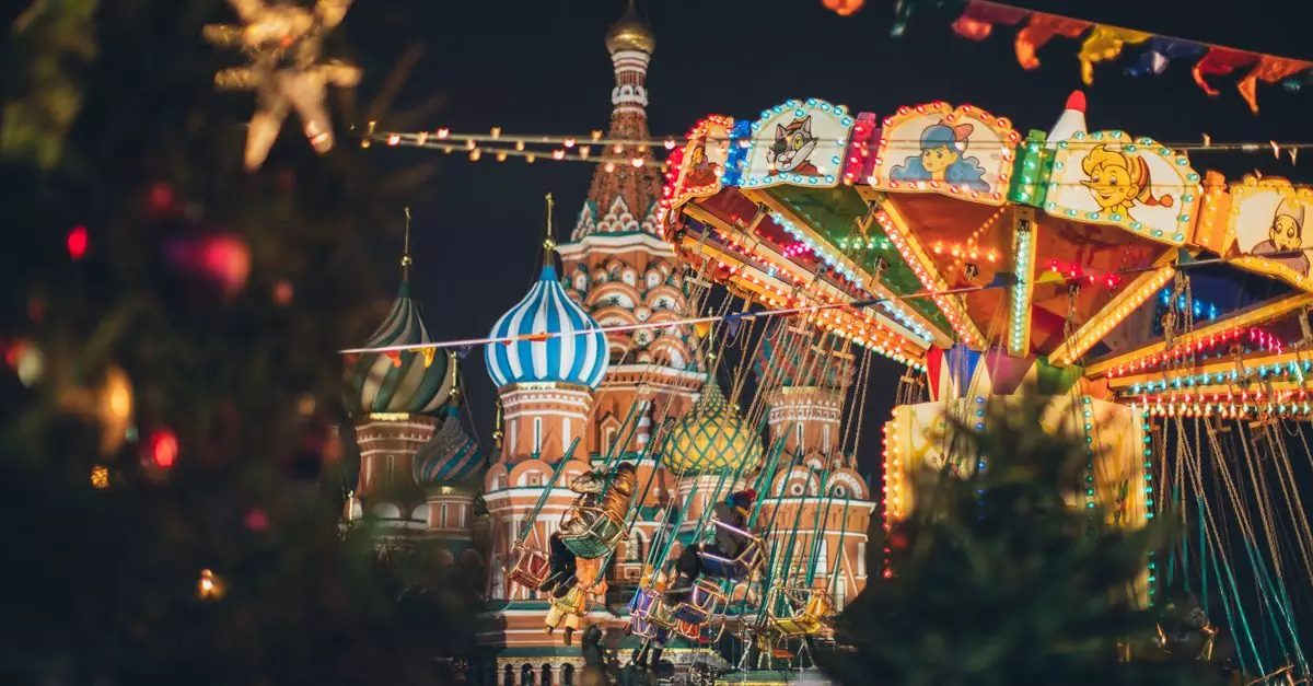Festive fairground on Red Square against famous Cathedral of Vasily Blessed in evening during Christmas holidays in Moscow