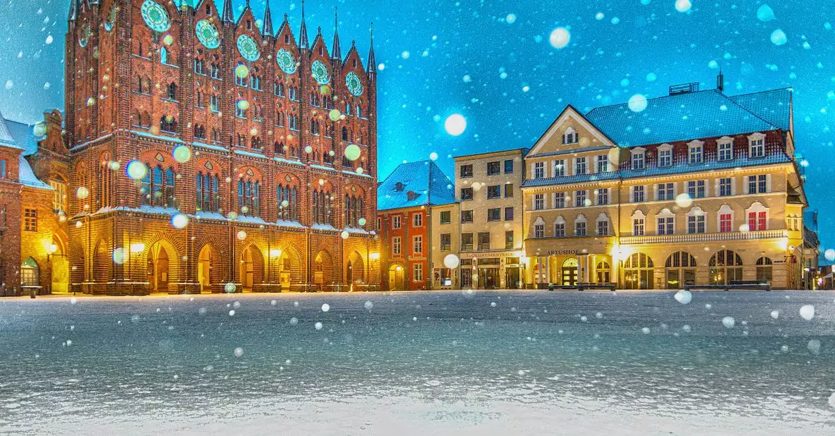 A beautifully illuminated evening scene of the snowy town square in Stralsund, Germany.