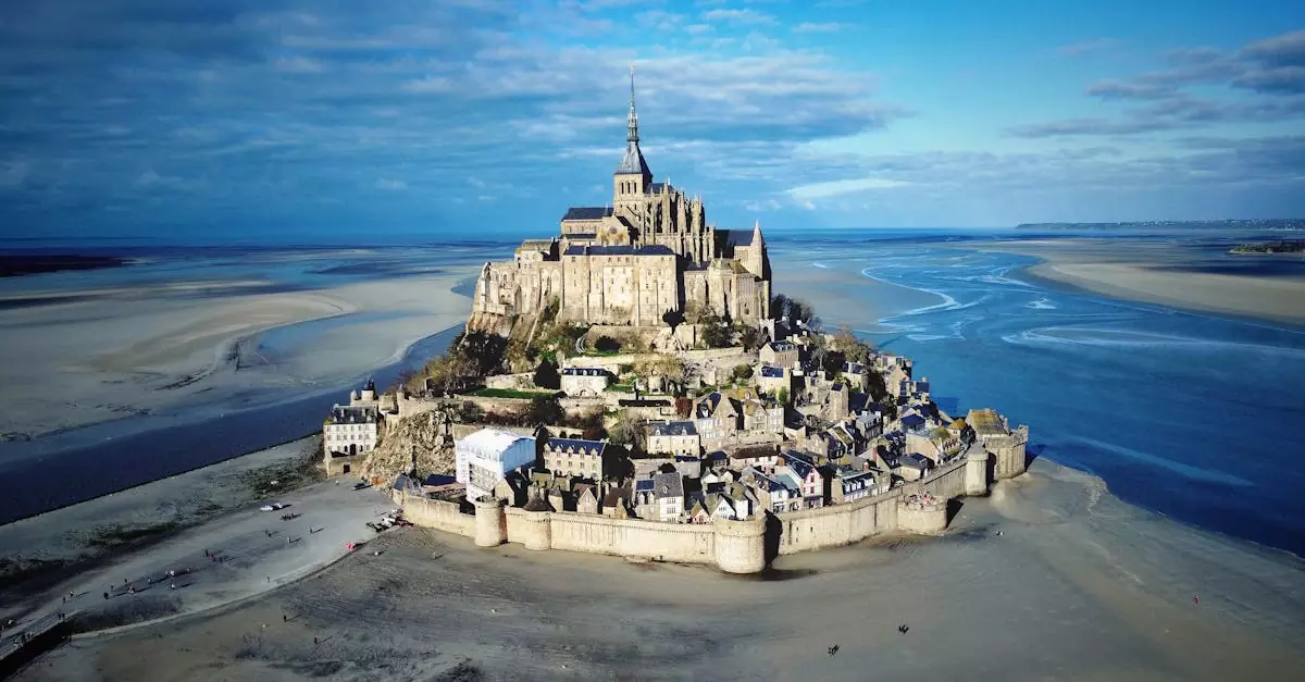 Stunning aerial view of Mont Saint-Michel in Normandy, France, showcasing the iconic island commune at low tide.