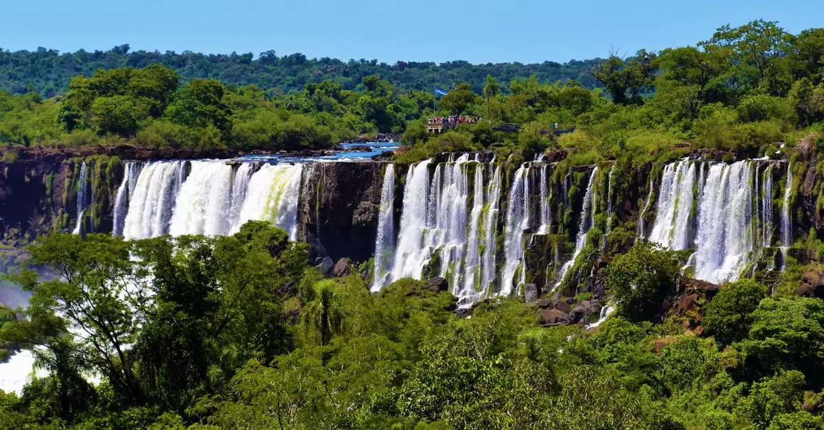 Lush greenery and cascading waters of Iguazu Falls, a natural wonder in Argentina's Misiones Province.