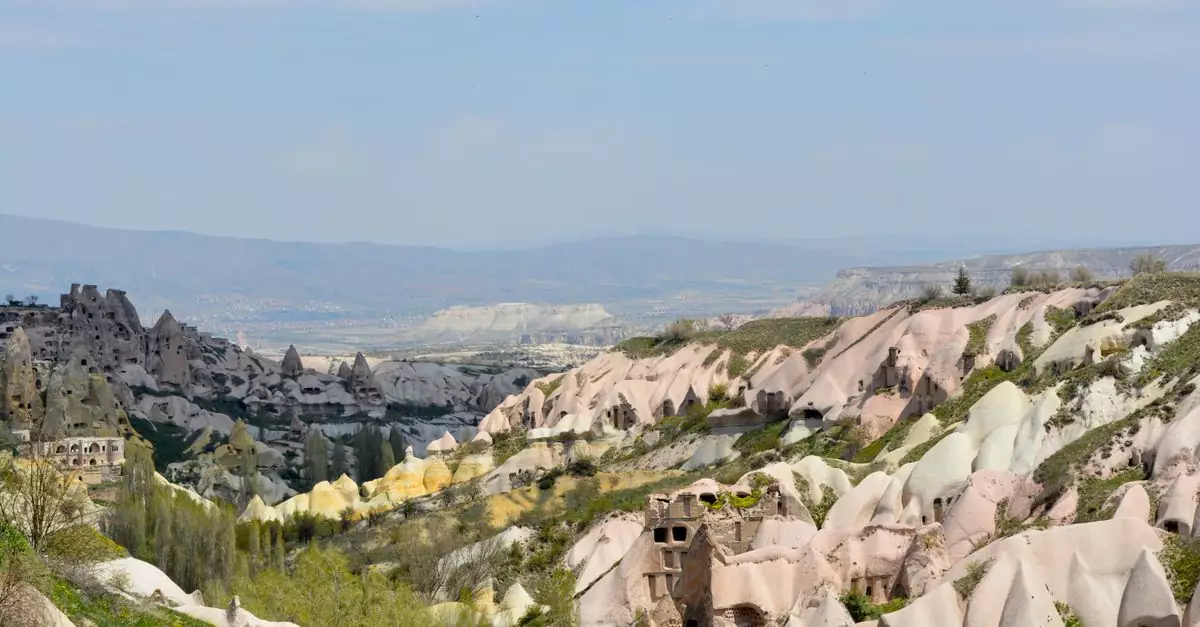 Discover the stunning rock formations of Cappadocia, T&uuml;rkiye, in this breathtaking landscape view.