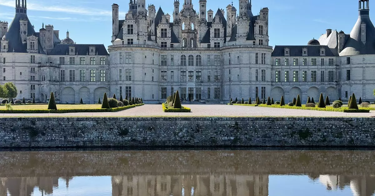Majestic Château de Chambord mirrored in the calm waters on a clear day.