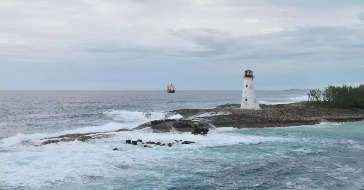 A scenic view of a lighthouse on a rocky coast with waves crashing and an ocean view.
