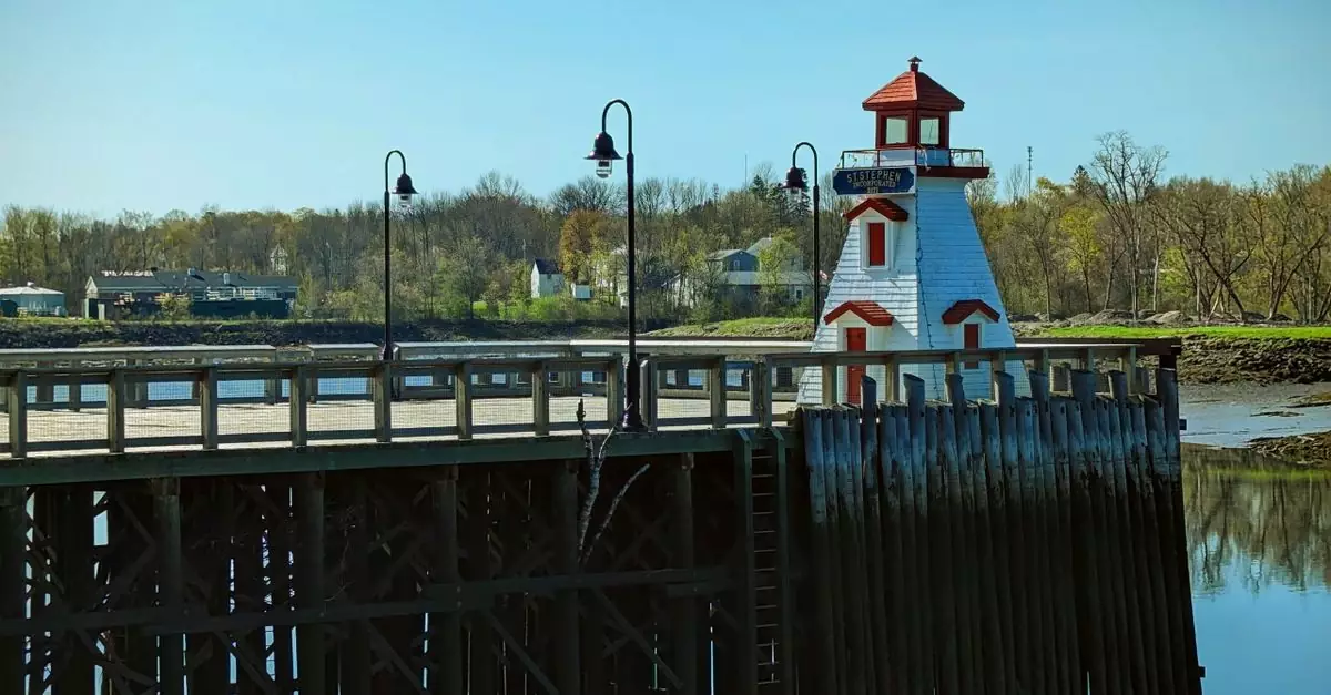 Picturesque scene of a riverside lighthouse with a boardwalk, perfect for travel and outdoor themes.