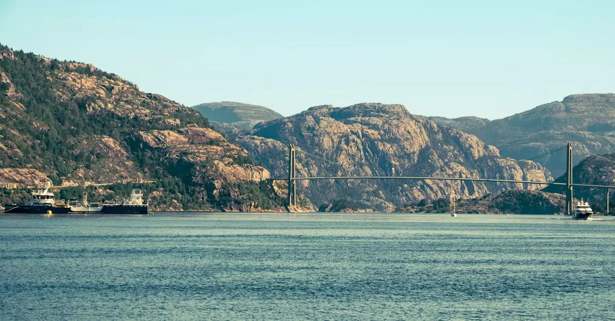 Picturesque view of the Hardanger Bridge spanning a fjord in Norway, surrounded by rugged mountains.