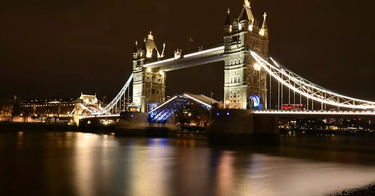 Iconic Tower Bridge beautifully illuminated at night reflecting on the River Thames.