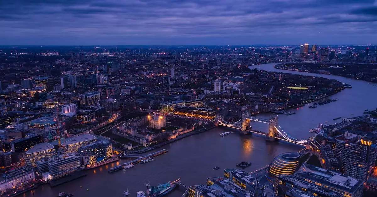 A breathtaking aerial view of London's Tower Bridge and the River Thames illuminated at twilight.