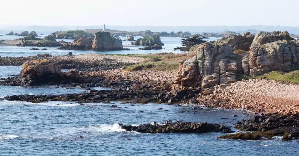Perfect Weekend Jersey Island: 2-Day Itinerary 2 Aerial view of rocky coastline on Île-de-Bréhat in Brittany, France with lush landscape and clear waters.