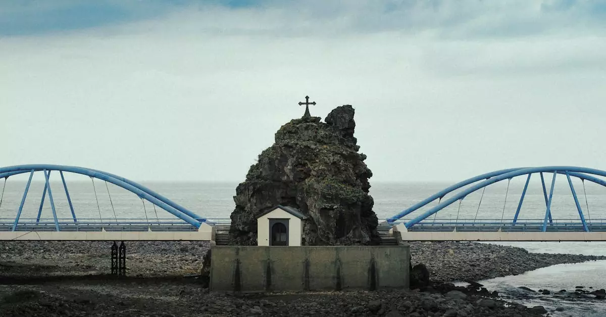 Scenic view of a bridge and rock formation with a cross in Madeira, Portugal.