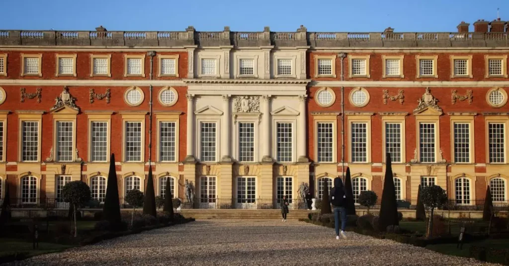 Stunning view of the Hampton Court Palace facade, showcasing baroque architecture and gardens in Molesey, England.