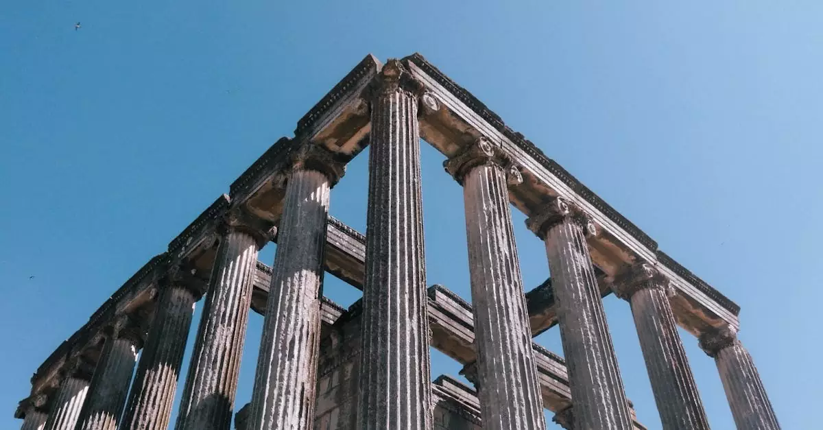 Historic Roman temple columns against a bright blue sky, showcasing ancient architecture.