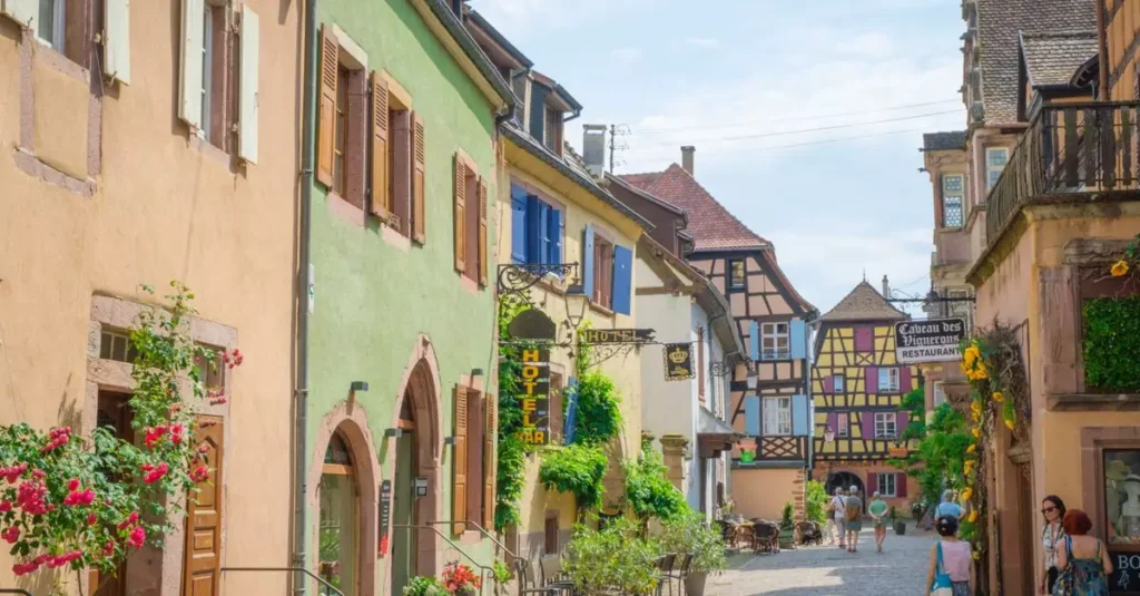 Picturesque street in Alsace, France showcasing vibrant facades and classic European architecture on a sunny day.