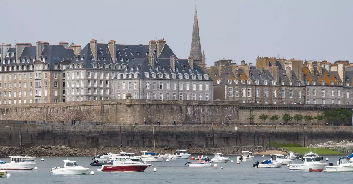 Picturesque view of Saint-Malo's historic buildings and boats along the coastline in Brittany, France.