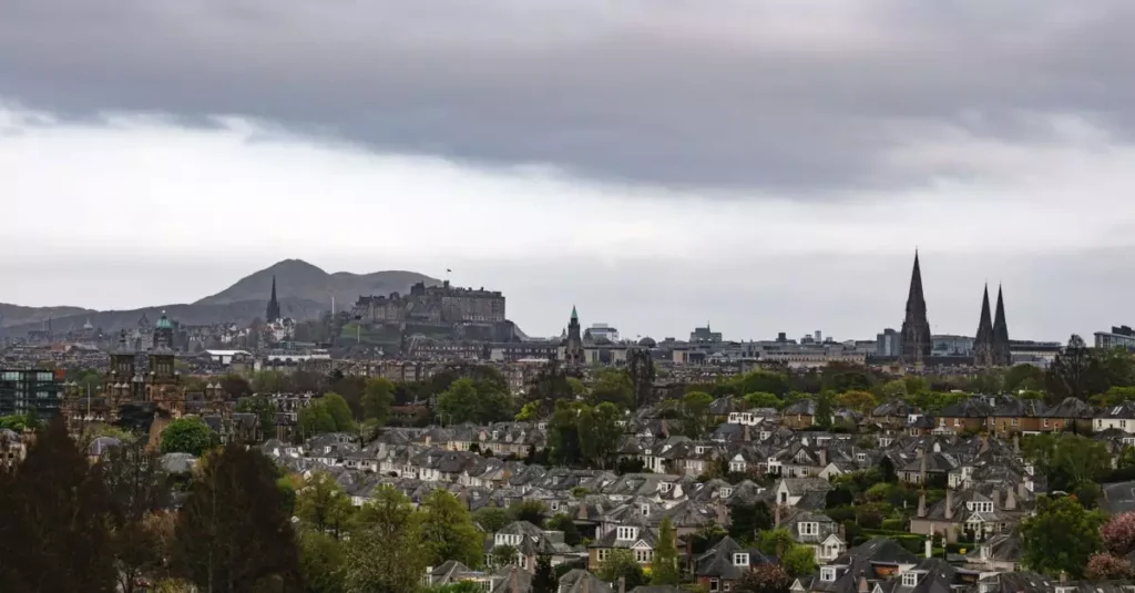 Discover the iconic Edinburgh skyline featuring historic Edinburgh Castle amidst the city's rooftops.