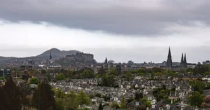 Discover the iconic Edinburgh skyline featuring historic Edinburgh Castle amidst the city's rooftops.