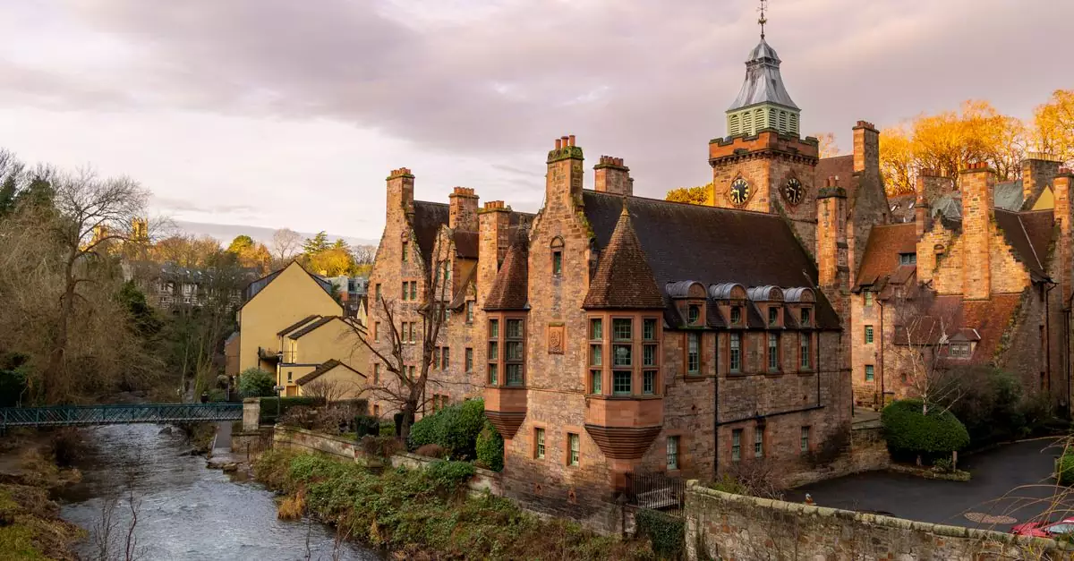 Picturesque scene of Dean Village at sunset with historic buildings and a flowing river in Edinburgh, Scotland.