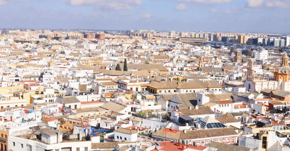 A breathtaking aerial shot showcasing the historic architecture of Seville, Spain under a vibrant sky.