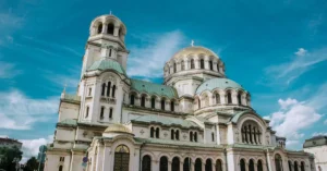 Majestic view of Alexander Nevsky Cathedral against a vibrant blue sky.