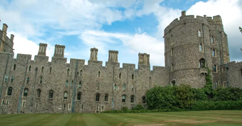 Things to Do in Windsor After Castle Visit 2 Windsor Castle's historic stone facade under a vibrant blue sky, showcasing its iconic turrets.