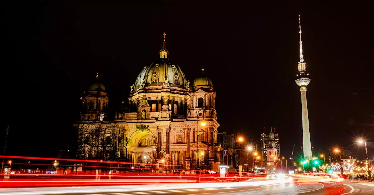 Long exposure of Berlin Cathedral and TV Tower at night with vibrant light trails.