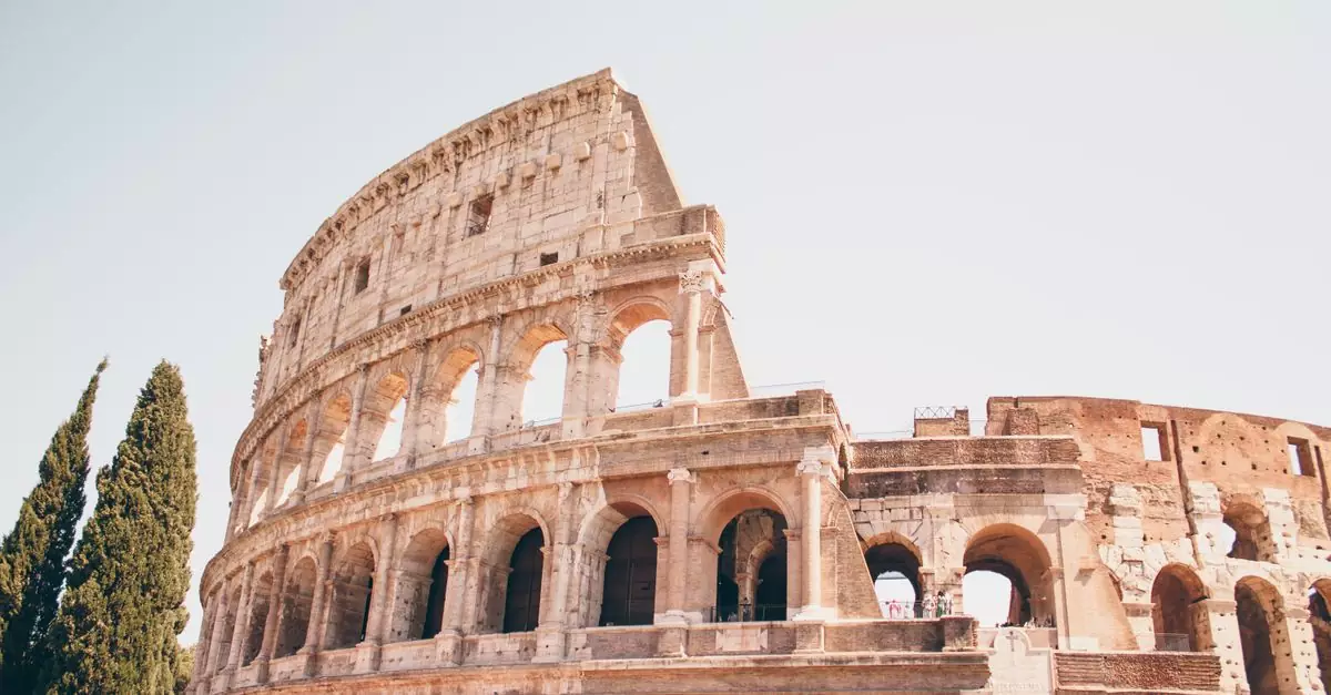 Experience the grandeur of the ancient Colosseum in Rome during a sunny day.