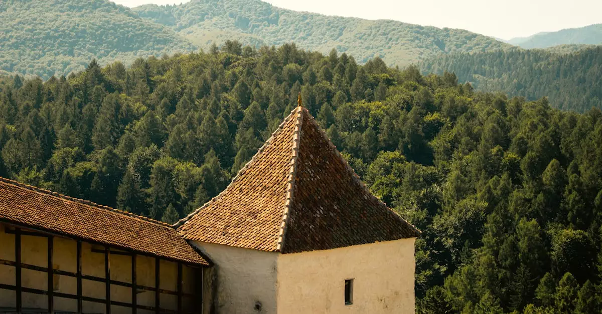 View of a medieval fortress tower in Transylvania surrounded by lush forests.