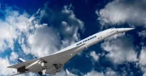 A stunning view of the Concorde aircraft soaring through a blue sky filled with clouds.