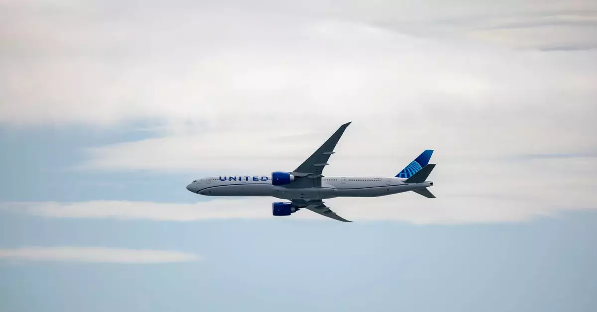 A United airplane soaring in the sky amidst clouds, showcasing modern aviation.