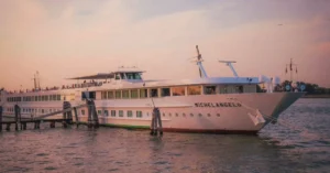Elegant cruise ship Michelangelo docked at Venice during sunset, capturing the serene ambiance of the Venetian waters.