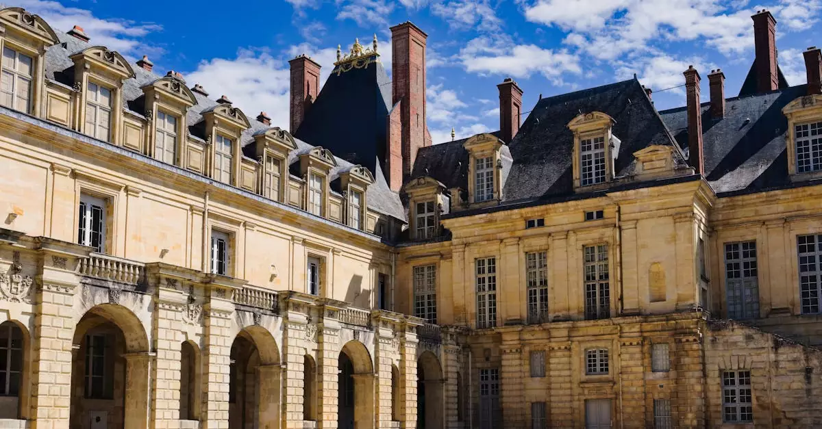 Stunning view of the Ch&acirc;teau de Fontainebleau under a vibrant blue sky, showcasing its historic architecture.