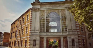 Stunning architecture featuring detailed facade with large arched windows under a clear sky.
