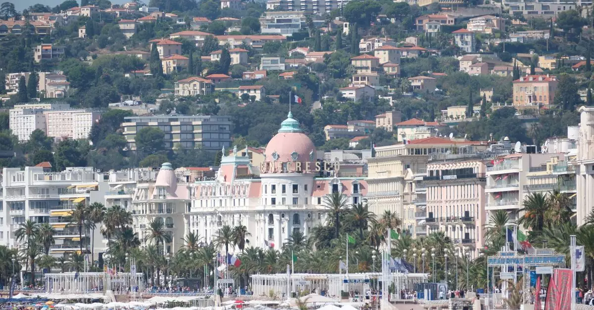 View of the famed beaches and luxurious hotel in Nice, France, during a vibrant summer day.