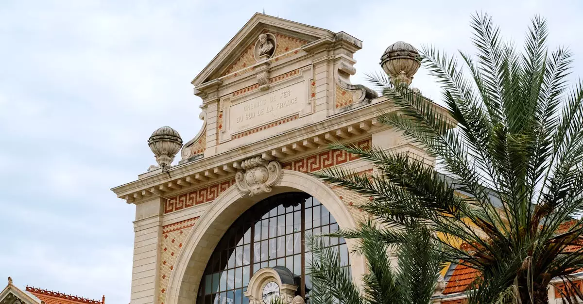 Classic French architecture with palm trees under a clear sky, highlighting intricate design and elegance.