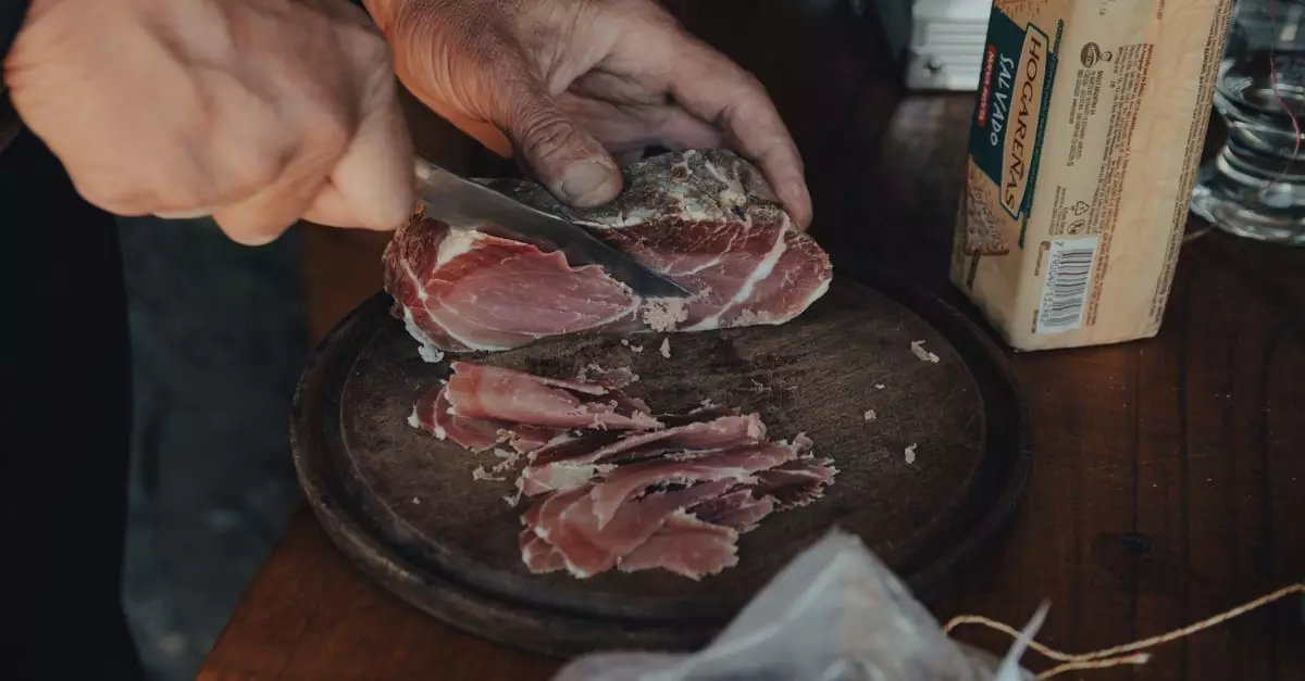 A hand expertly slices cured ham on a wooden board, capturing the essence of rustic food preparation.