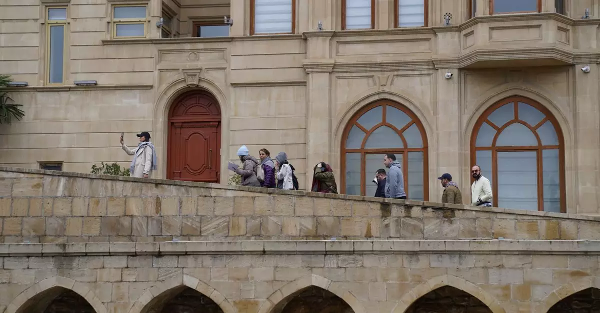 Tourists walking along a stone walkway of a historic building. Capturing memories and experiences.