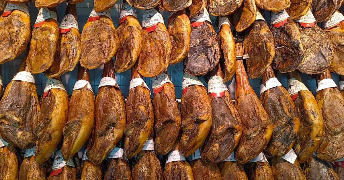 Captivating display of traditional Jam&oacute;n Ib&eacute;rico hanging in a vibrant Spanish market.