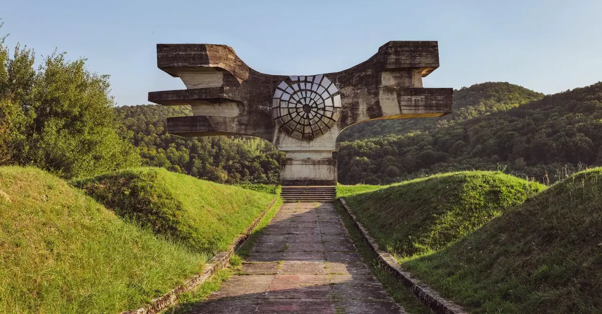 Historic World War II monument in Podgarić, Croatia surrounded by green hills.
