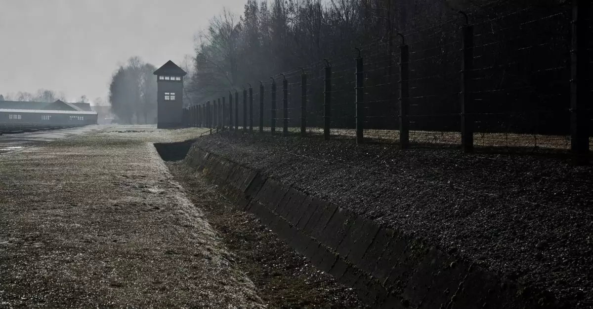 Barbed wire fence and watchtower at Dachau Concentration Camp in Germany.