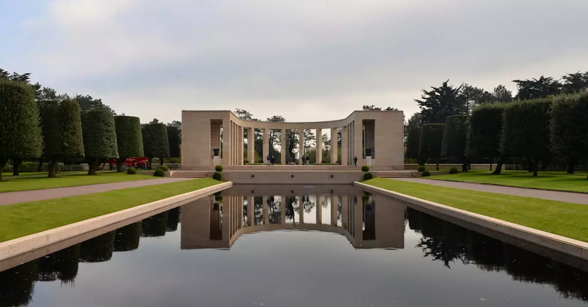 Calm and reflective atmosphere at Normandy American Cemetery Memorial with water feature and manicured gardens.